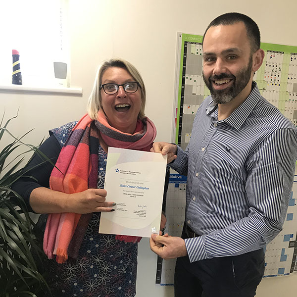 Claire celebrating her NVQ distinction with Dominic Spayne CEO. Pictured with her NVQ certificate