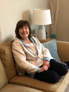 2020 Lesley on sofa 225x300 - Shared Lives South West Carer Lesley