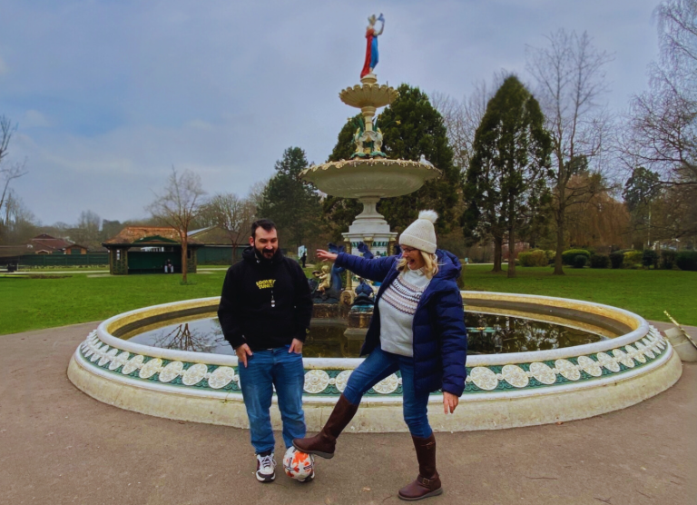 Shared Lives Carer Sandra with Kris at Vivary Park, Taunton. Pictured at the fountain playing football.